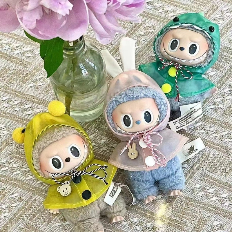 Three Labubu dolls wearing Raincoat for Monster in yellow, pink, and green. Toy accessory fits all Labubu dolls, ideal for collectors.